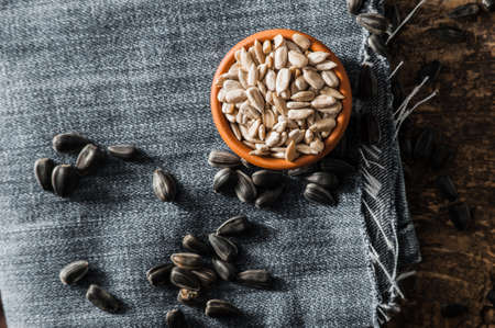 Shelled sunflower seeds in wood bowl. Sunflower close-up.Fresh Sunflower seed and oil.の写真素材