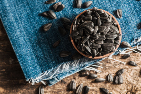 Shelled sunflower seeds in wood bowl. Sunflower close-up.Fresh Sunflower seed and oil.の写真素材
