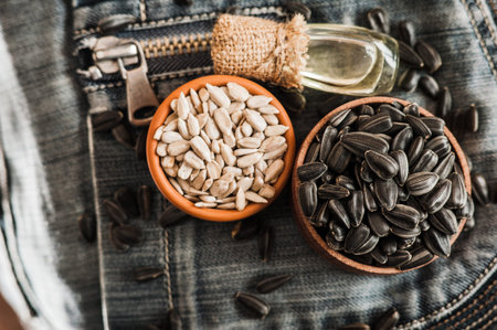 Fresh Sunflower seed and oil. Shelled sunflower seeds in wood bowl. sunflower