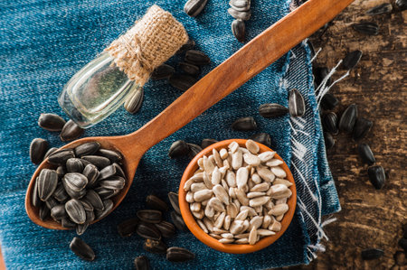 Fresh Sunflower seed and oil. Shelled sunflower seeds in wood bowl. sunflowerの写真素材