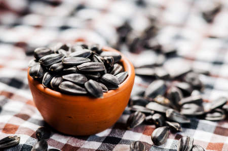 Fresh Sunflower seed and oil. Shelled sunflower seeds in wood bowl. sunflowerの写真素材