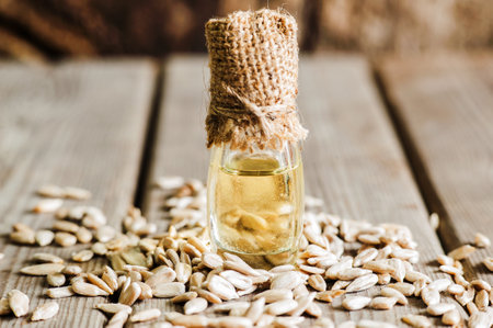 Fresh Sunflower seed and oil. Shelled sunflower seeds in wood bowl. sunflowerの写真素材