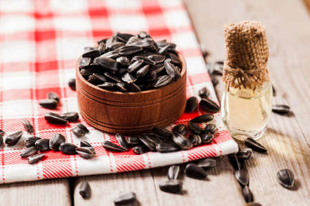 Fresh Sunflower seed and oil. Shelled sunflower seeds in wood bowl. sunflowerの写真素材