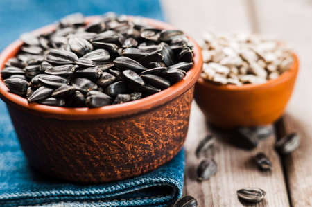 Fresh Sunflower seed and oil. Shelled sunflower seeds in wood bowl. sunflowerの写真素材