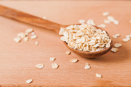 Oat ears of grain on a wooden table, oatmeal. Bounteous harvest. A Healthy fresh Dry Oat mealの写真素材