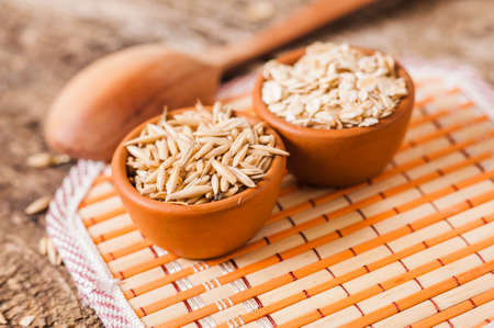 Oat ears of grain on a wooden table, oatmeal. Bounteous harvest. A Healthy fresh Dry Oat mealの写真素材