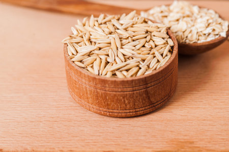 Oat ears of grain on a wooden table, oatmeal. Bounteous harvest. A Healthy fresh Dry Oat meal