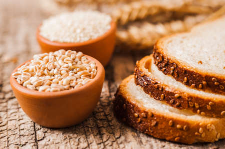 Oat ears of grain on a wooden table, oatmeal. Bounteous harvest. A Healthy fresh Dry Oat mealの写真素材