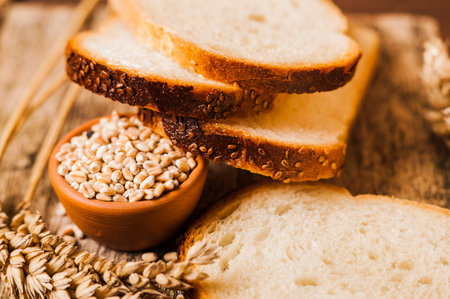 Photo of wheat grains and flour on the wooden table
