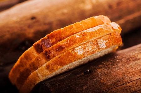 Fresh bread sliced on a wooden board, bread crust, delicious, close-up
