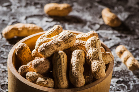 walnut kernels in a wooden dish and shell nuts