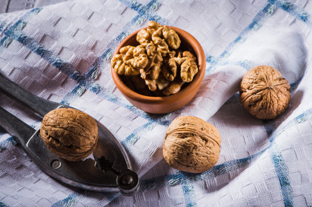 walnut kernels in a wooden dish and shell nuts