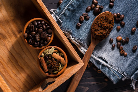 Anise stars and brown sugar in a vintage silver cups on a dark textural wooden background. selective...