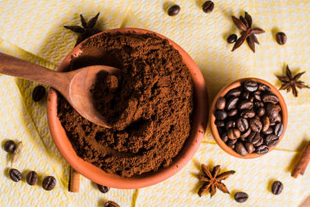 Spices for coffee cardamom, star anise, cinnamon.coffee beans.Roasted coffee beans goals.Bowl of delicious ground arabica coffee.の写真素材