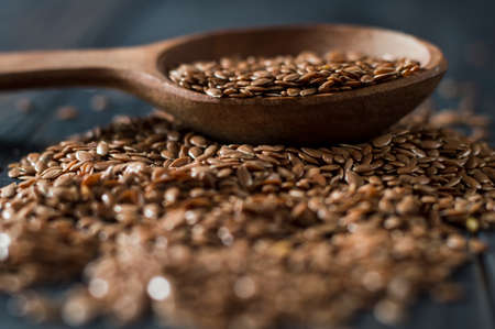 Flax seed spoon on a dark background.の写真素材