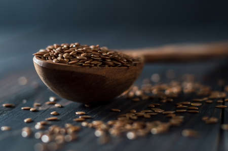 Flax seed spoon on a dark background.の写真素材