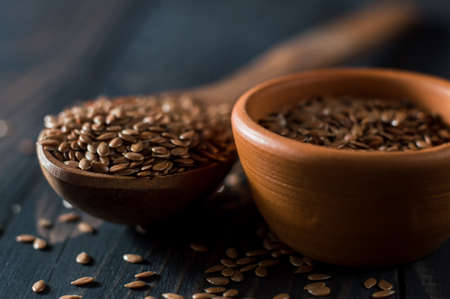 Flax seed spoon on a dark background.の写真素材