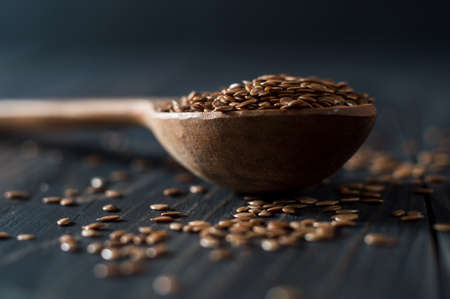 Flax seed spoon on a dark background.の写真素材