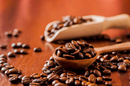 Background of ground coffee texture. Coffee beans are scon wooden table. attered on the table.の写真素材