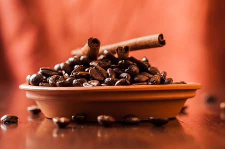Background of ground coffee texture. Coffee beans are scon wooden table. attered on the table.の写真素材