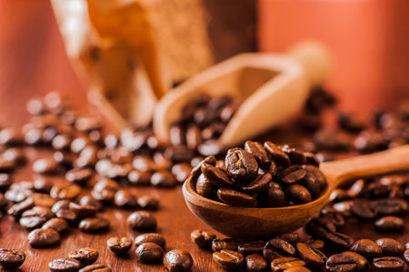 Background of ground coffee texture. Coffee beans are scon wooden table. attered on the table.Packaging for coffee.Closeup of coffee beans background.coffee beansの写真素材