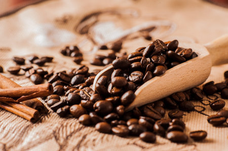 Background of ground coffee texture. Coffee beans are scon wooden table. attered on the...