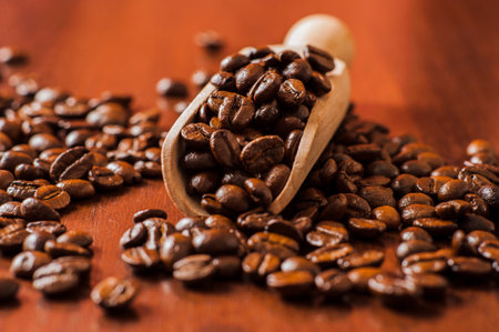 Background of ground coffee texture. Coffee beans are scon wooden table. attered on the table.Packaging for coffee.Closeup of coffee beans background.coffee beansの写真素材