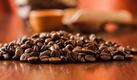 Background of ground coffee texture. Coffee beans are scon wooden table. attered on the table.Packaging for coffee.Closeup of coffee beans background.coffee beansの写真素材