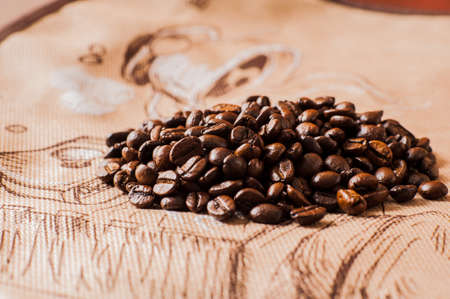 Background of ground coffee texture. Coffee beans are scon wooden table. attered on the table.Packaging for coffee.Closeup of coffee beans background.coffee beansの写真素材