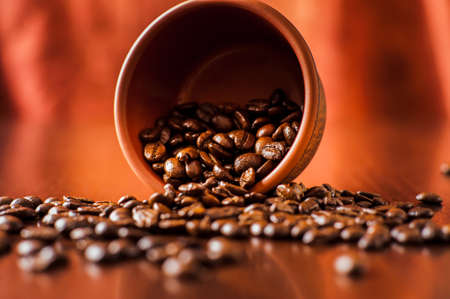 Background of ground coffee texture. Coffee beans are scon wooden table. attered on the table.Packaging for coffee.Closeup of coffee beans background.coffee beansの写真素材