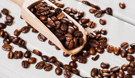 Cup of coffee, bag and scoop.coffee beans on wooden table. Background of ground coffee texture....