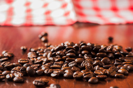 Cup of coffee, bag and scoop.coffee beans on wooden table. Background of ground coffee texture....
