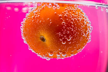 Cherry tomatoes in water. water drops.の写真素材