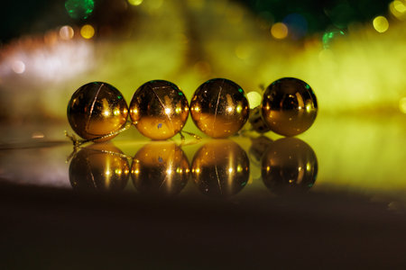 Christmas background with fir twigs, red berries, cones and Xmas lights on dark abstract background with plenty of text space.の写真素材