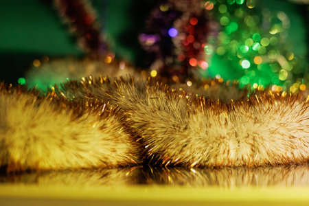 Christmas tree decorated with toys. Christmas background with fir twigs, red berries, cones and Xmas lights on dark abstract background with plenty of text space.の写真素材