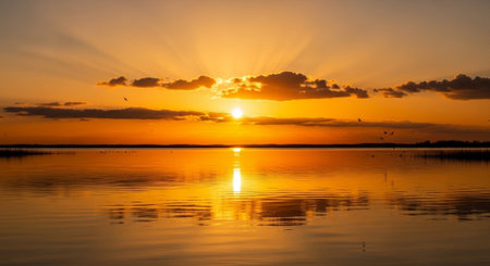 Sunset over the lake with reflection in water. Nature background.の写真素材
