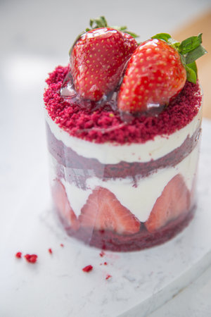 Red cake with strawberries. Strawberry dessert with cream. Sweet strawberry pie isolated on white.の写真素材