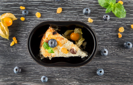 A dish in a black disposable container from catering on a concrete background, dietary catering, ready meals with you, healthy foodの写真素材
