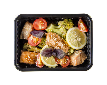 A dish in a black disposable container from catering on a concrete background, dietary catering, ready meals with you, healthy foodの写真素材