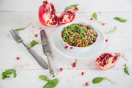 Healthy quinoa salad with pomegranate, green peas and nutsの写真素材