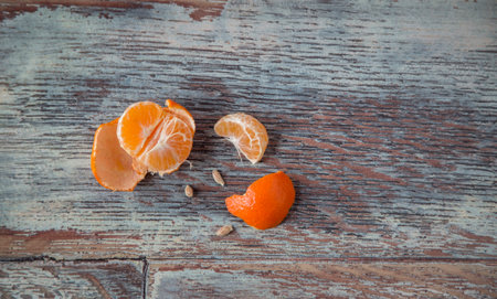 New Years Christmas still life: pine branch next to tangerine oranges on a wooden backgroundの写真素材