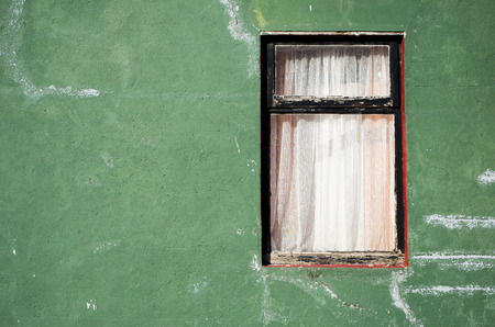 old window on a green wallの写真素材