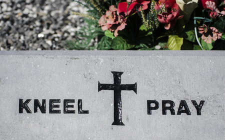 kneel and pray sign