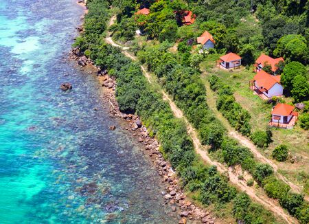 Beautiful tropical island with blue clear water and granite stones. Ocean coast. Top view.の写真素材