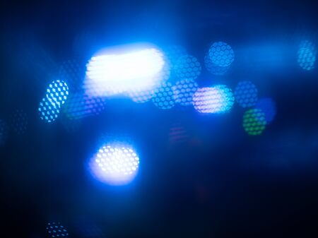 Abstract blue lights background, unfocused night lights, abstract blurred different colored lights backdrop, colored bright website pattern, banner header or sidebar graphic artの写真素材