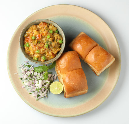 Pav Bhaji is a fast food dish from India, Thick and spicy vegetable curry, fried and served with a soft bread Bun Pav and butter. selective focusの写真素材