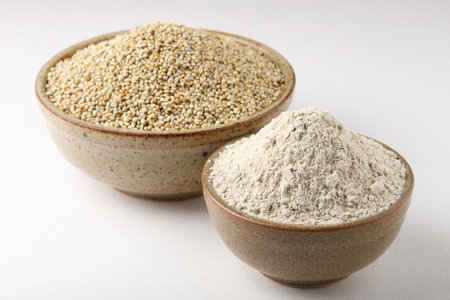 Bajra pearl millet sorghum grains with it's flour or powder in a bowl selective focusの写真素材
