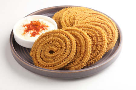 Traditional Indian Diwali snacks Chakali,murukku, Indian Traditional Tea Time Snack Chakli, a deep fried snack, It is known as Chakali, Murukku, Muruku, Murkoo, Chakriの写真素材