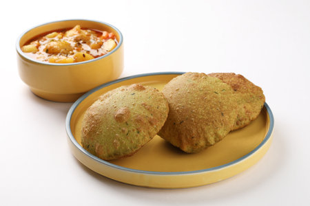 Indian Palak Poori Or Palak Puri Made Of Wheat Flour mixed with blanched Spinach Leaves Served with potato Sabzi Or Veg Curry Sabji. Served in whiteの写真素材
