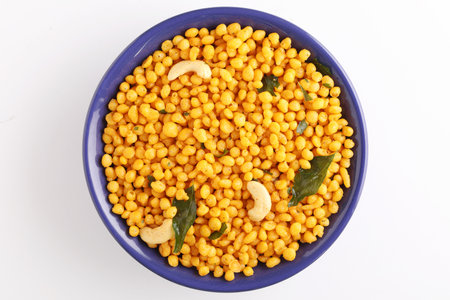 Small Boondi balls spicy Indian snack made from chickpea flour with cashew nuts on white backgroundの写真素材